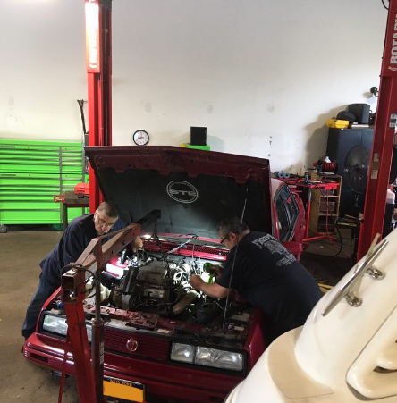 mechanics working on car